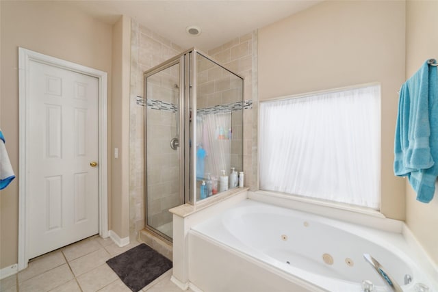 bathroom with tile patterned flooring and separate shower and tub