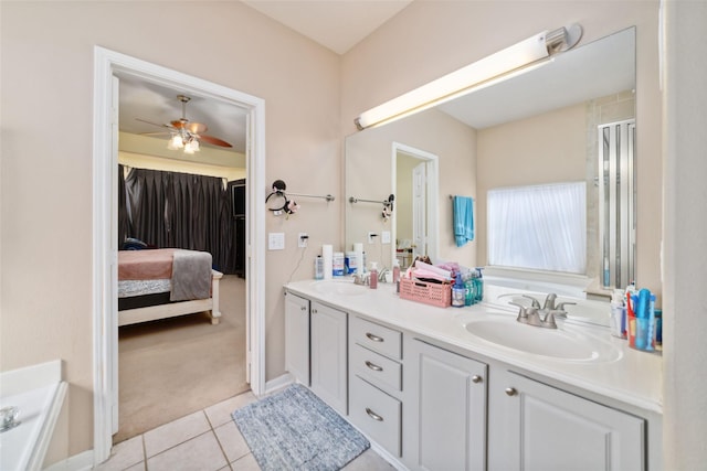 bathroom with a tub, ceiling fan, tile patterned flooring, and vanity