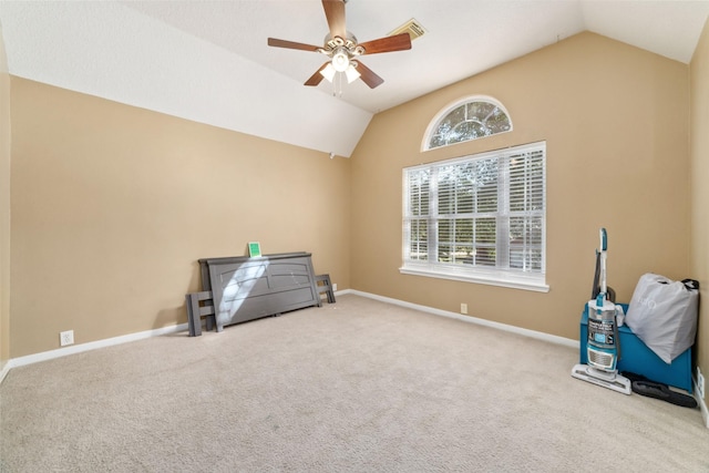 misc room with carpet flooring, vaulted ceiling, a wealth of natural light, and ceiling fan