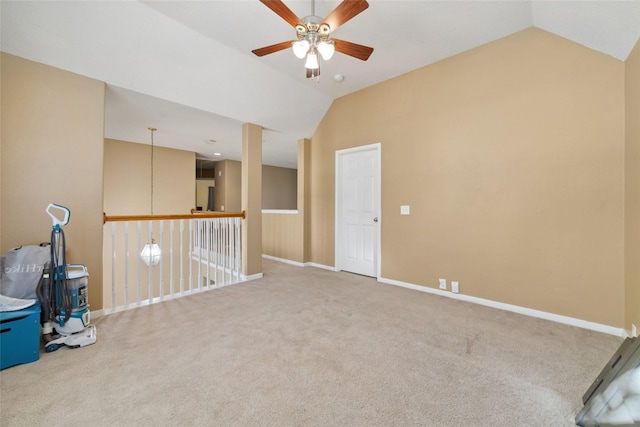 empty room featuring carpet flooring, ceiling fan, and vaulted ceiling