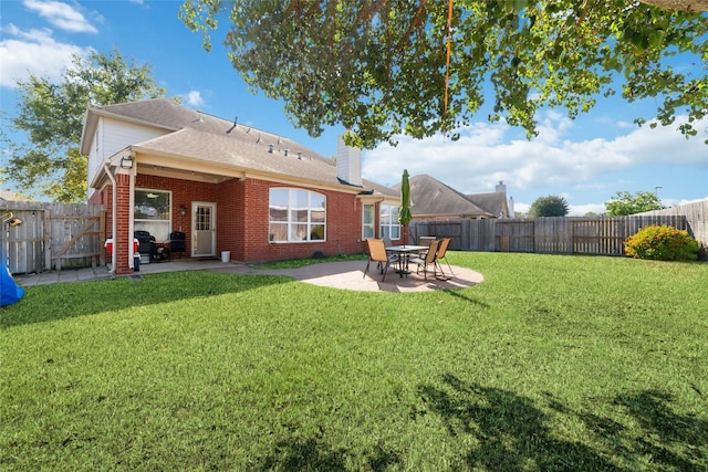 back of property featuring a yard and a patio area