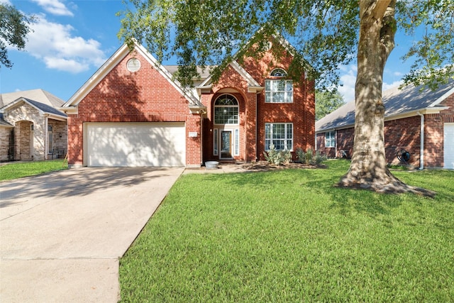 view of property featuring a front yard and a garage