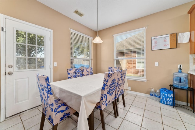 dining space with breakfast area, light tile patterned floors, and a healthy amount of sunlight