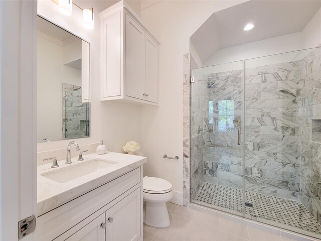 bathroom with vanity, tile patterned flooring, a shower with door, and toilet