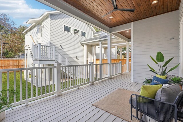 deck with a lawn and ceiling fan