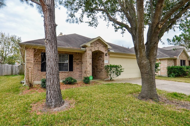 single story home featuring a garage and a front yard