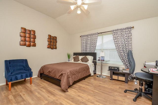 bedroom featuring light wood-type flooring, vaulted ceiling, and ceiling fan