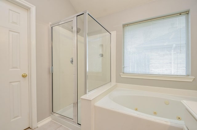 bathroom featuring tile patterned flooring and shower with separate bathtub