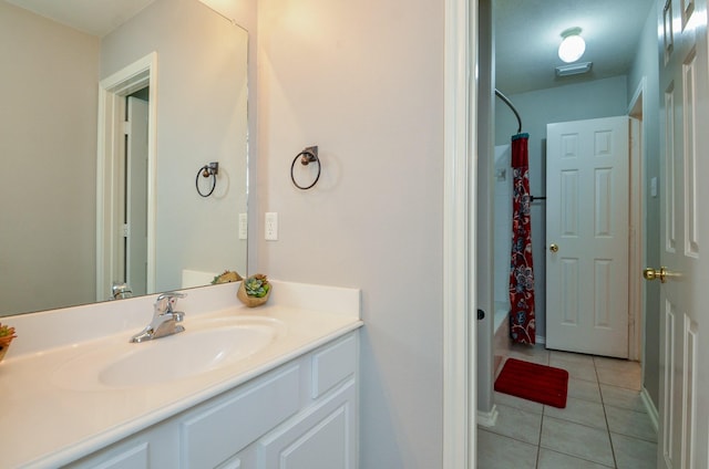 bathroom with tile patterned floors, vanity, and shower / tub combo