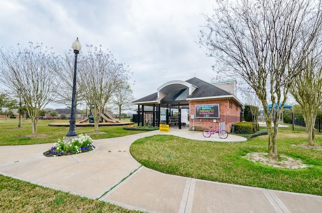 view of community featuring a playground and a yard