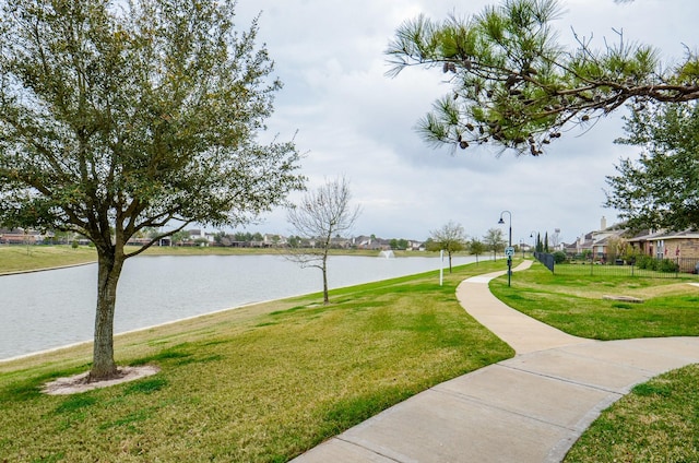 surrounding community featuring a yard and a water view