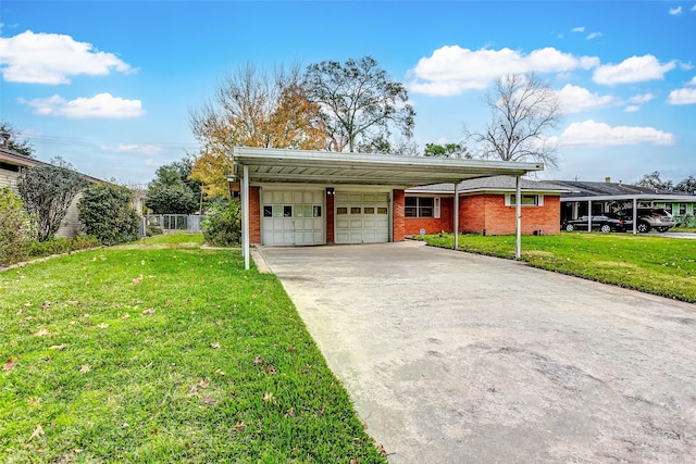 view of front of property featuring a garage, a front yard, and a carport