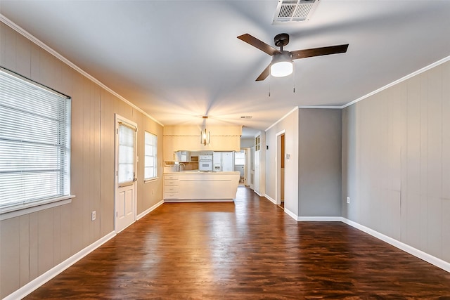 unfurnished living room with crown molding, sink, ceiling fan, and dark wood-type flooring