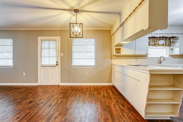 kitchen with crown molding, tile countertops, a chandelier, dark hardwood / wood-style floors, and hanging light fixtures