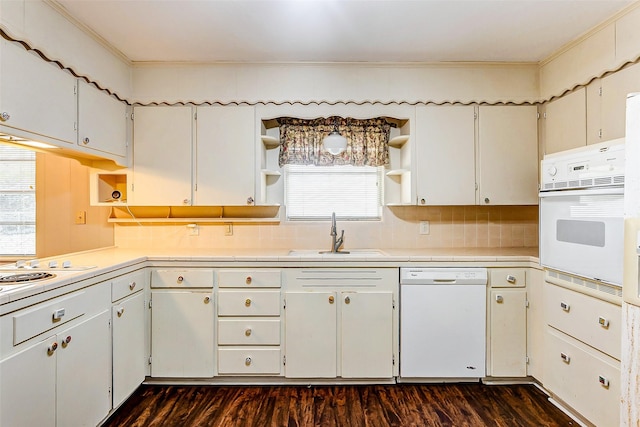 kitchen with white appliances, white cabinetry, crown molding, and sink