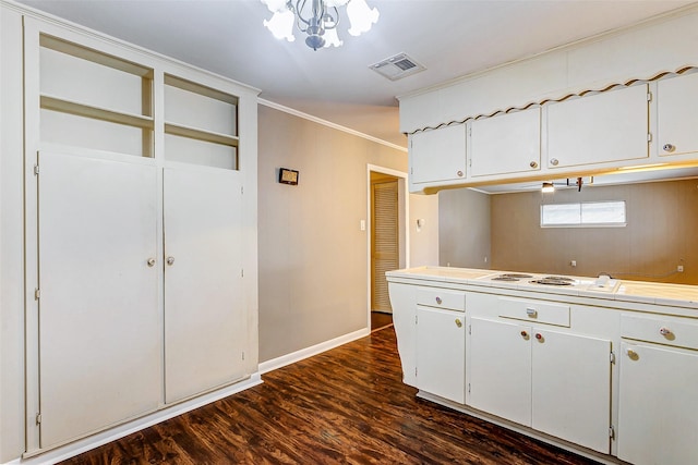 kitchen with white cabinets, crown molding, and dark wood-type flooring