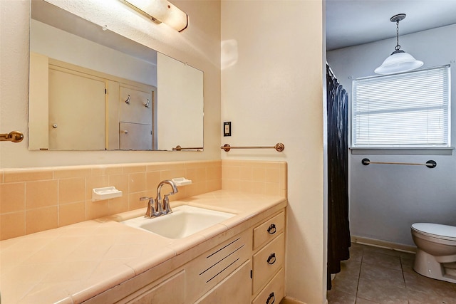 bathroom featuring tile patterned flooring, vanity, toilet, and backsplash