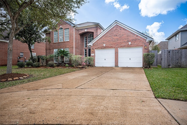 view of property featuring a front lawn and a garage