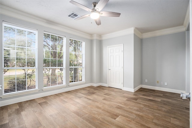 spare room with a wealth of natural light, ceiling fan, and wood-type flooring