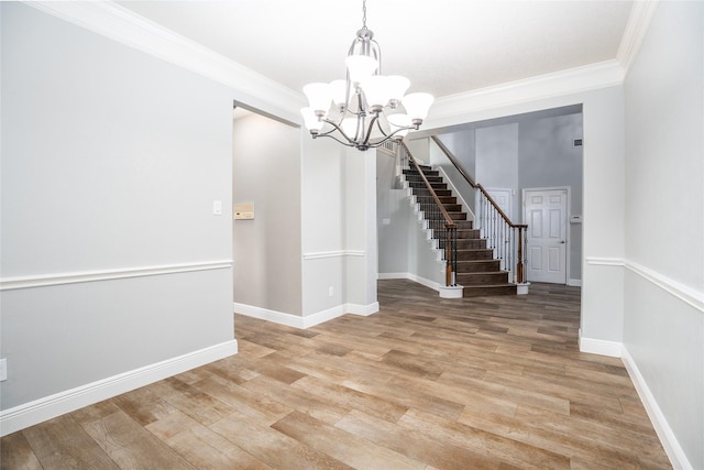 interior space featuring wood-type flooring, crown molding, and a chandelier