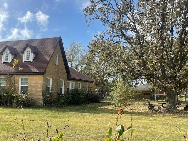 view of side of home with a lawn