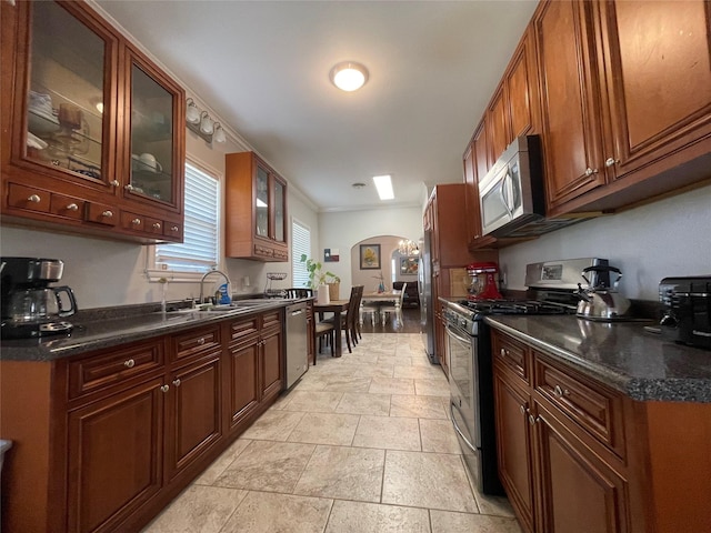 kitchen with crown molding, sink, and appliances with stainless steel finishes