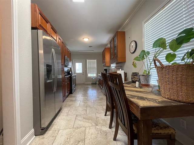 kitchen featuring stainless steel appliances and crown molding