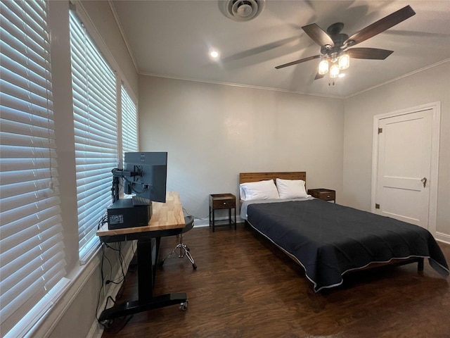 bedroom featuring dark hardwood / wood-style floors, ceiling fan, and crown molding