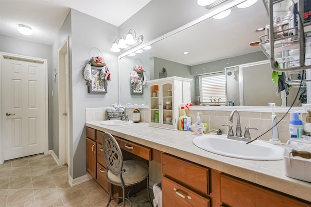 bathroom featuring decorative backsplash, vanity, and tile patterned floors