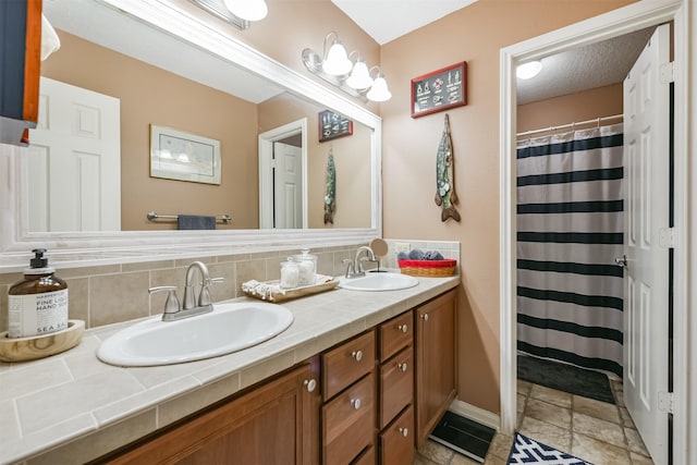 bathroom featuring vanity and tasteful backsplash