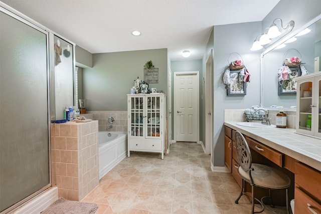 bathroom with tile patterned flooring, vanity, and separate shower and tub