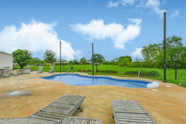 view of swimming pool featuring a yard and a patio