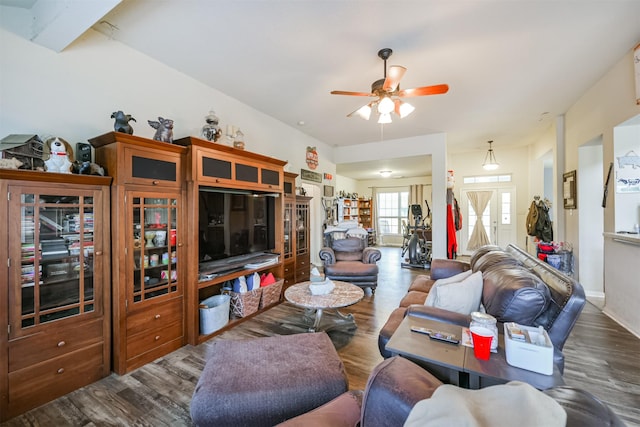 living room with ceiling fan and dark hardwood / wood-style flooring