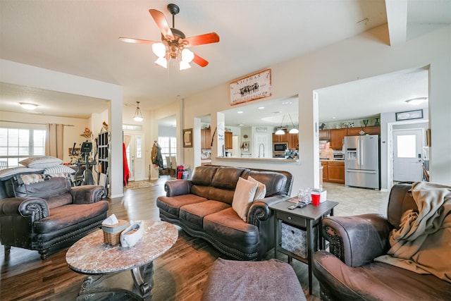 living room featuring ceiling fan and light hardwood / wood-style flooring