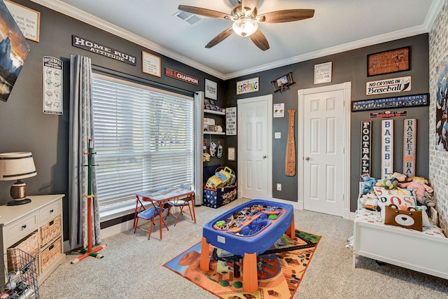 playroom with crown molding, ceiling fan, and light colored carpet