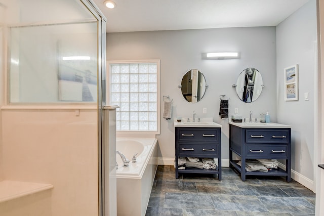 bathroom featuring vanity and a bath