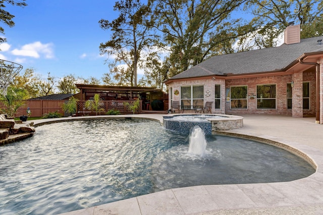 view of pool with an in ground hot tub, pool water feature, and a patio area