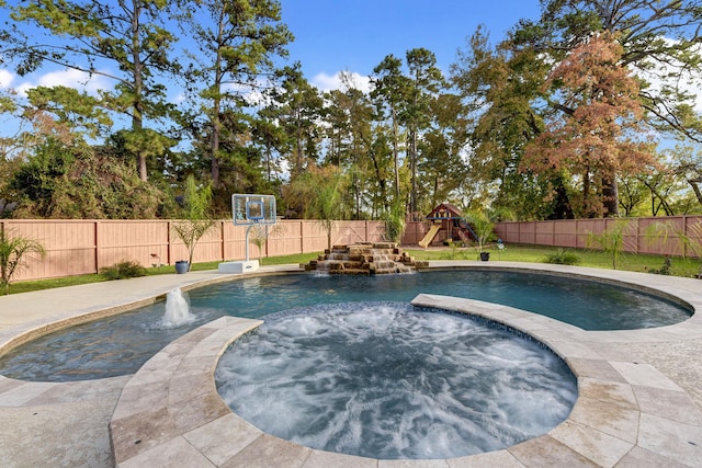 view of pool featuring a playground, an in ground hot tub, and pool water feature