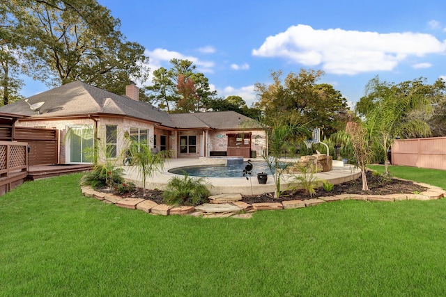 back of property with a yard, a patio area, and a pool side deck