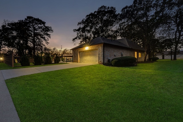 property exterior at dusk with a yard and a garage