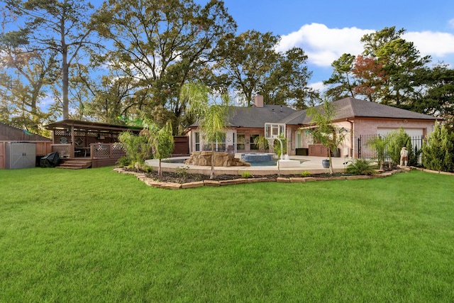 back of house with a deck, a storage unit, and a lawn