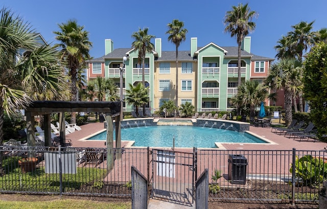 view of pool featuring pool water feature and a patio