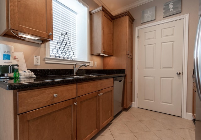 kitchen with stainless steel dishwasher, dark stone counters, crown molding, sink, and light tile patterned floors