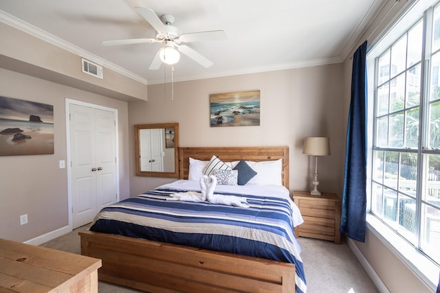 carpeted bedroom featuring multiple windows, crown molding, and ceiling fan