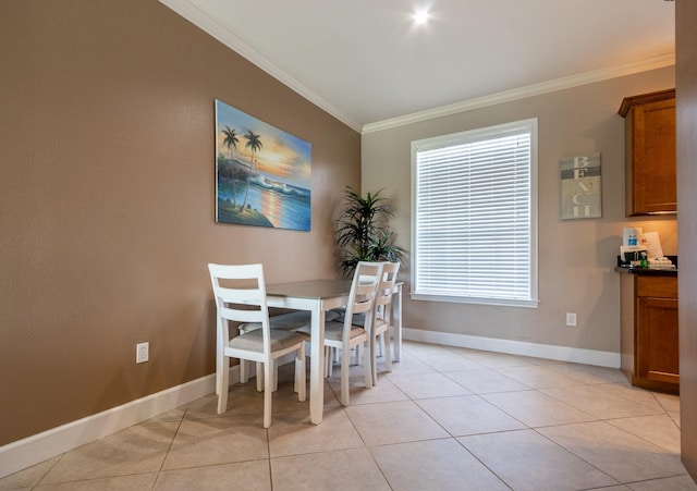 dining area with light tile patterned floors and ornamental molding