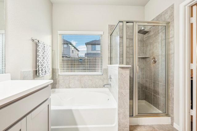 bathroom with shower with separate bathtub and vanity