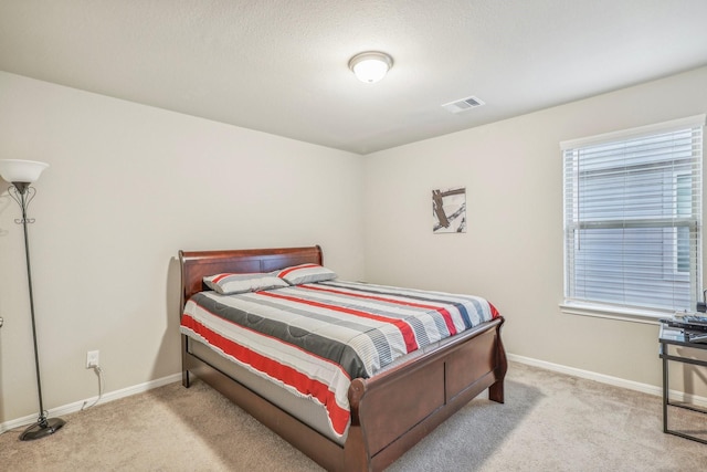 carpeted bedroom featuring a textured ceiling