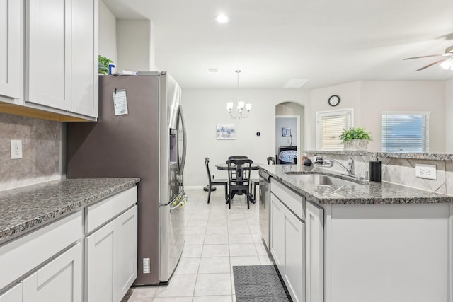 kitchen with white cabinets, appliances with stainless steel finishes, backsplash, and sink