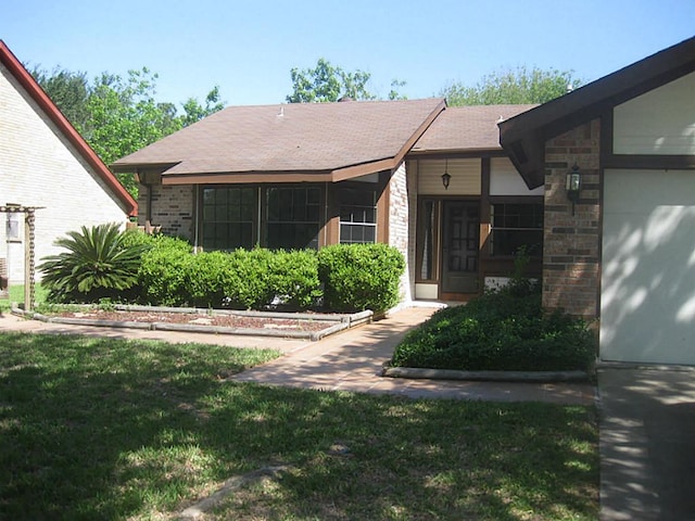 property entrance featuring a yard and a garage