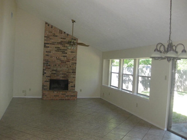 unfurnished living room featuring a brick fireplace, high vaulted ceiling, a textured ceiling, light tile patterned flooring, and ceiling fan with notable chandelier